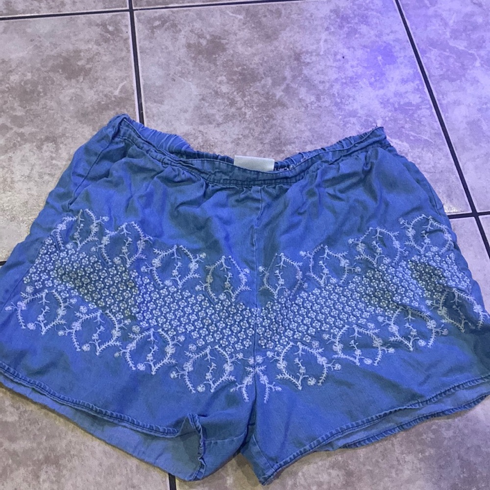 Light blue high waisted shorts from The Room with white designs.